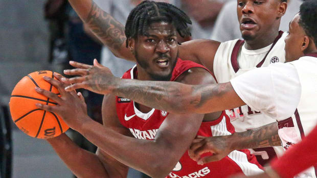 Arkansas Razorbacks forward Makhi Mitchell (15) controls the ball against Mississippi State Bulldogs guard Shawn Jones Jr. (5) and forward D.J. Jeffries (0) defend during the first half at Humphrey Coliseum.